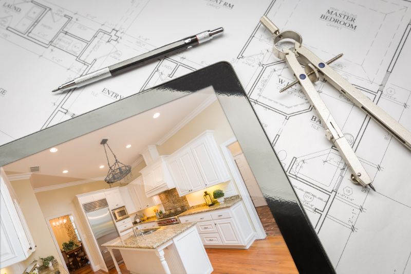computer tablet showing finished kitchen on house plans pencil